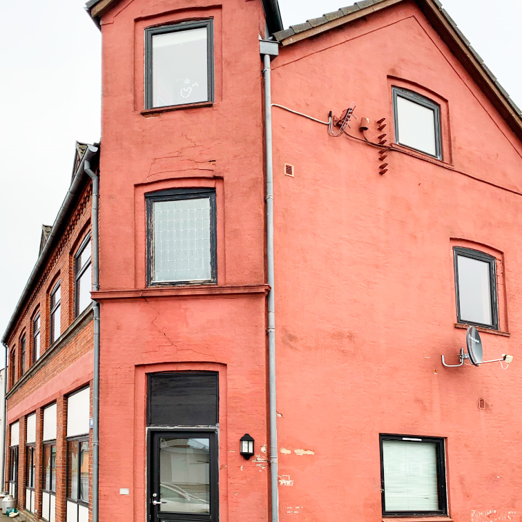 Facaden, som den fremstod før renoveringen. Oprindeligt var den i synlige mursten, men på et tidspunkt blev den pudset op.